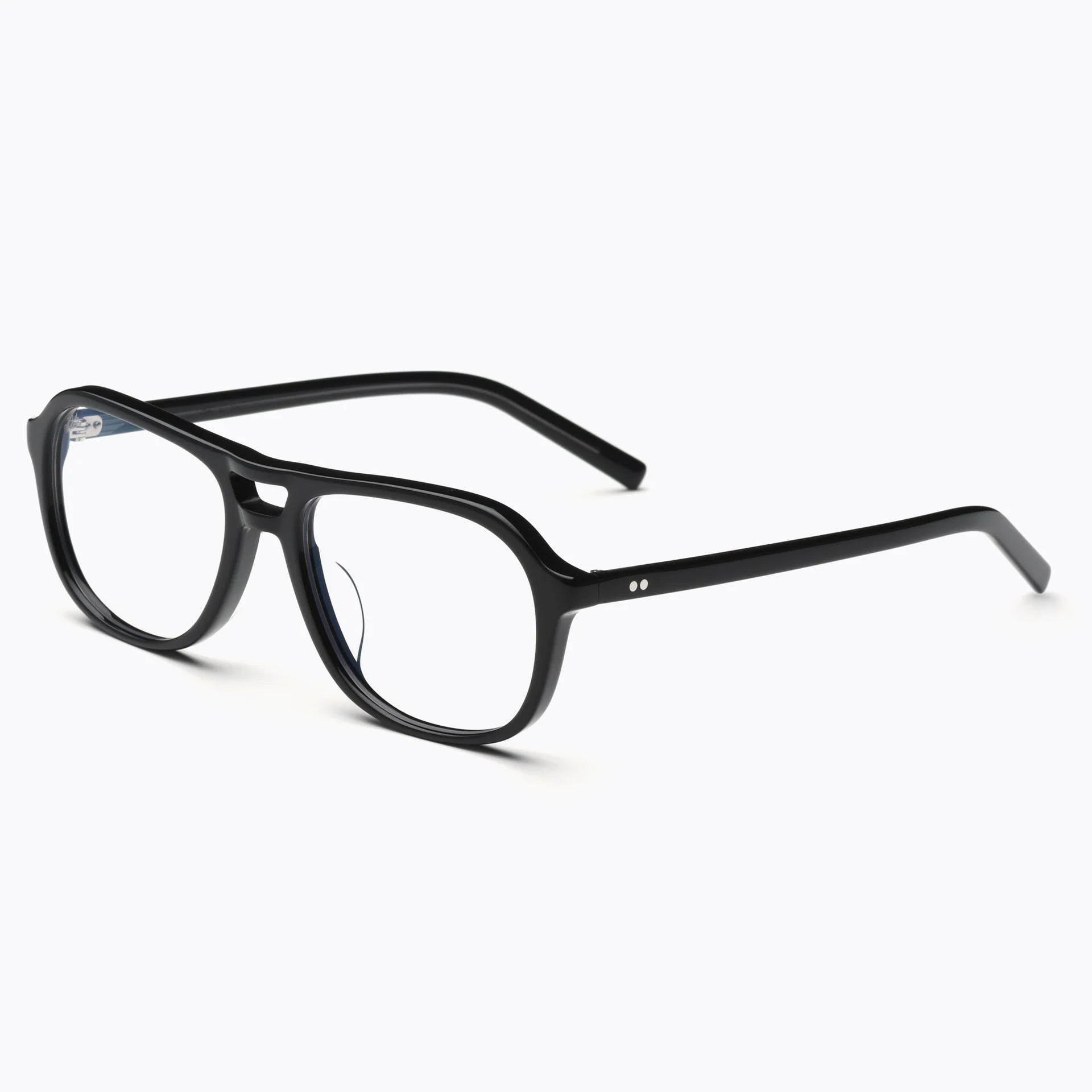 Akila Myca black rectangular eyeglasses by Akila, featuring clear blue-light-filtering lenses, rest on a white background. The prescription-ready frames have a subtle curve along the brow line and are accented with two small silver dots near each temple.