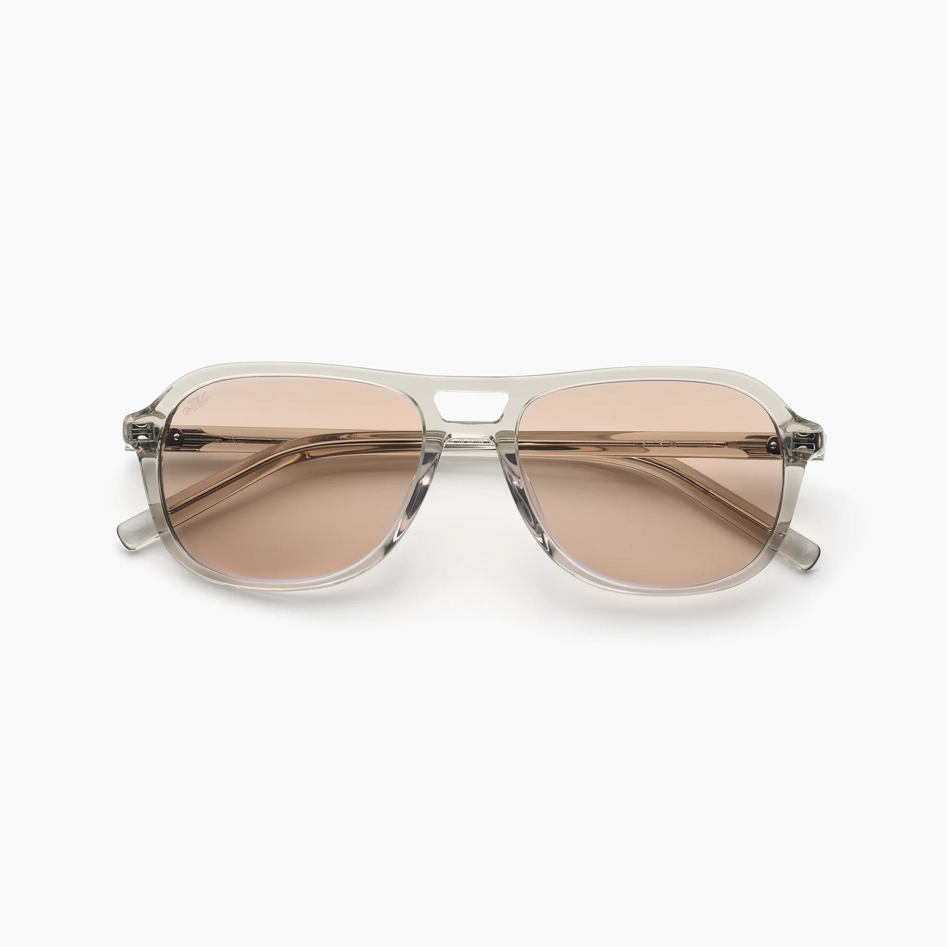 Sunglasses with a clear frame and brown lenses on a white background