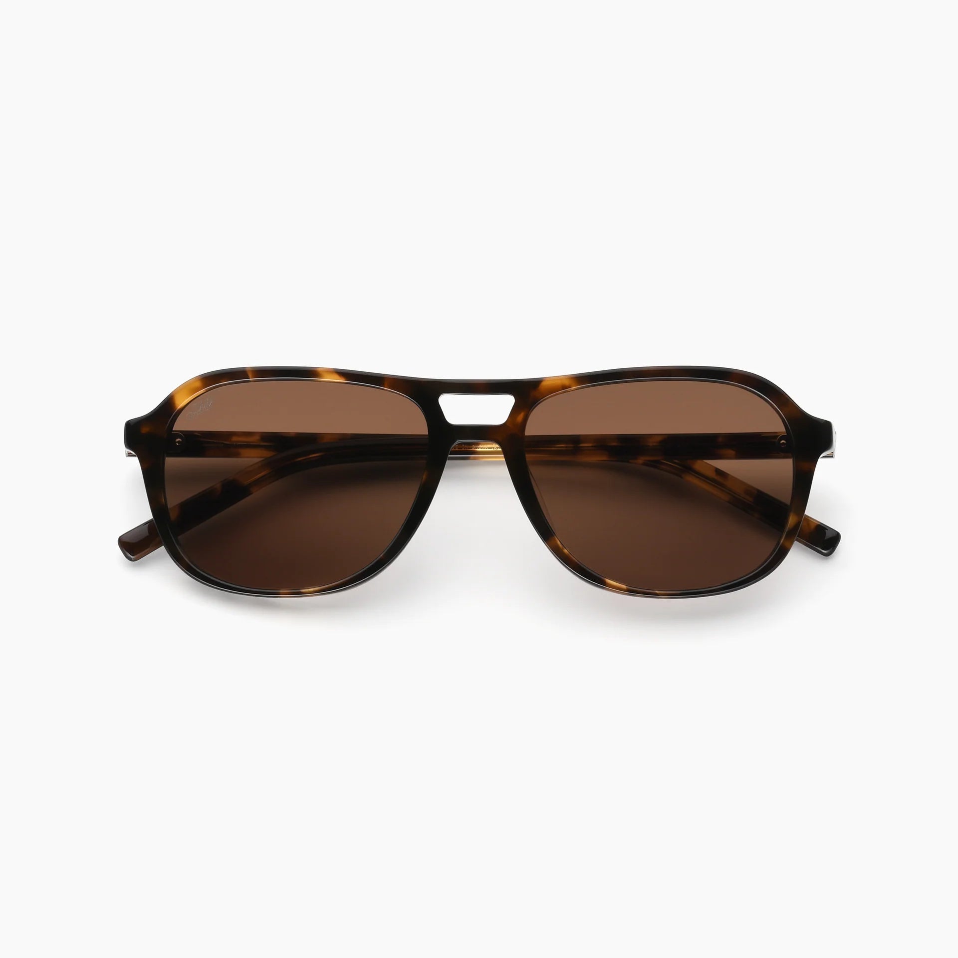 Sunglasses with tortoiseshell frame and brown lenses on a white background