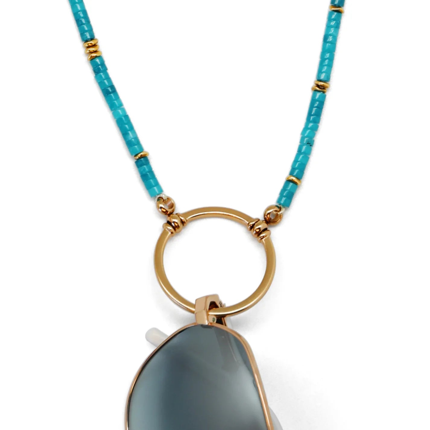 Necklace with a gold ring and gray pendant on a white background