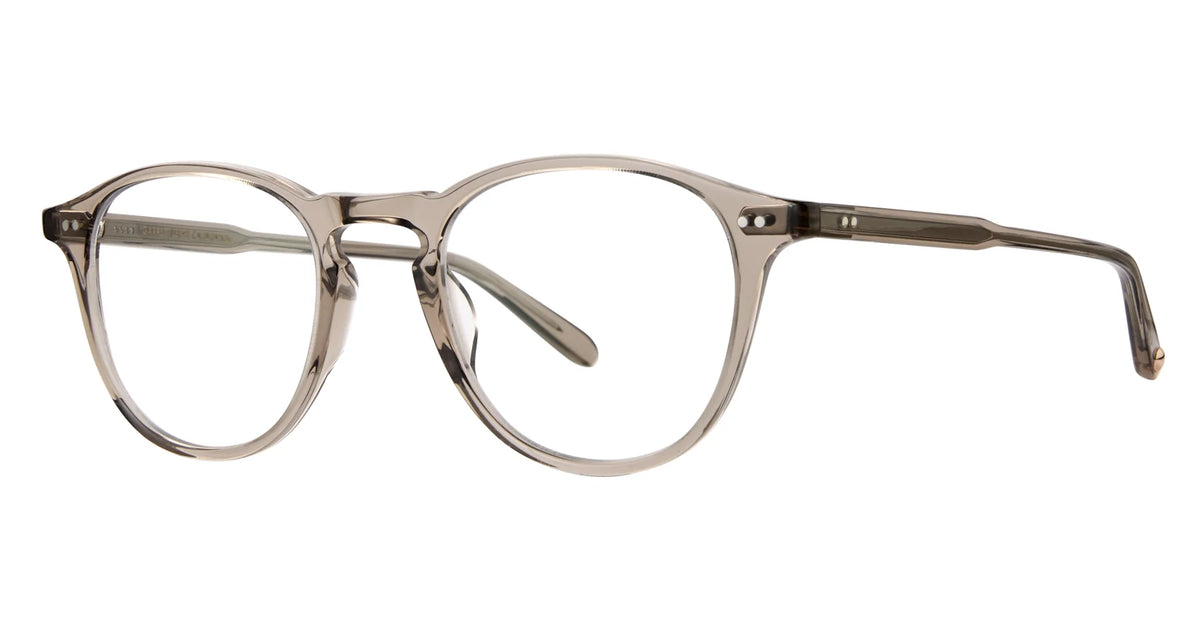 The Garrett Leight Hampton 44 eyeglasses by Garrett Leight feature clear acetate frames with round lenses and thin profiles, shown from the front with one temple arm extending backward. Inspired by classic P3 silhouettes, these optical frames capture the timeless style associated with the iconic Hampton design.