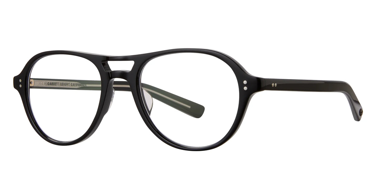 The Garrett Leight Hancock by Garrett Leight features black round eyeglasses with a keyhole bridge and silver rivet details on the frame and temples, displayed against a white background—a sophisticated example of handcrafted eyewear that distinguishes itself from classic aviator and navigator sunglasses.