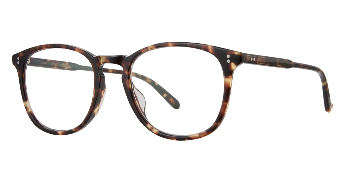 The Garrett Leight Kinney 47 eyeglasses by Garrett Leight feature brown tortoiseshell frames with round, optical quality lenses, a keyhole bridge, thin arms, and two small silver accents near each hinge.