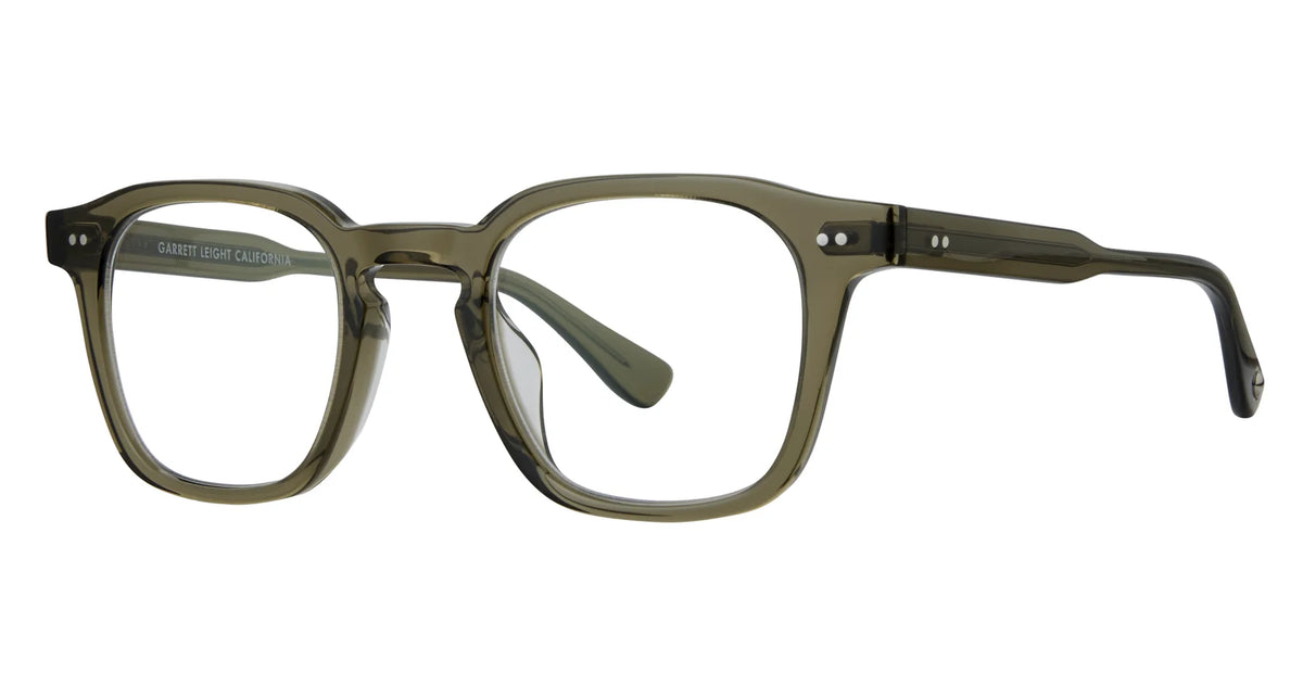 Garrett Leight Verdugo eyeglasses by Garrett Leight feature a square-shaped design with a translucent olive green frame and clear lenses, accented with silver details on the front corners and temples. Inspired by the classic aesthetics of GLCO eyewear, these frames blend contemporary style with lasting comfort and durability. The clear lenses are easily upgradeable to provide 100% UV protection, just like the Verdugo Sun sunglasses.