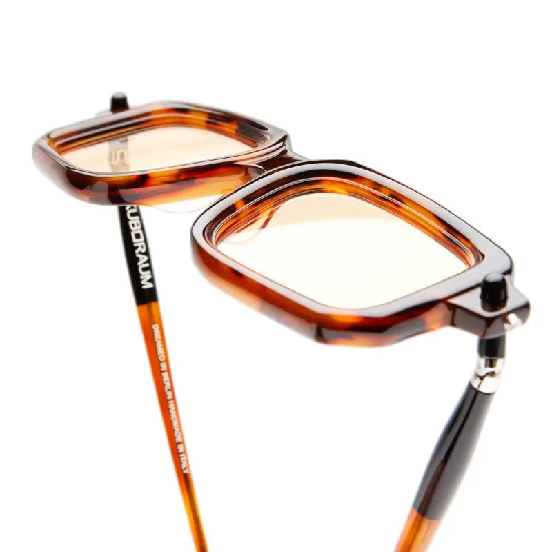 Tortoiseshell eyeglasses with gold accents on a white background
