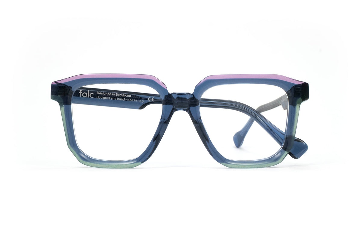 Folc Pulso square-frame glasses in contemporary Italian acetate with a translucent blue frame, featuring a purple top rim and green lower rim.