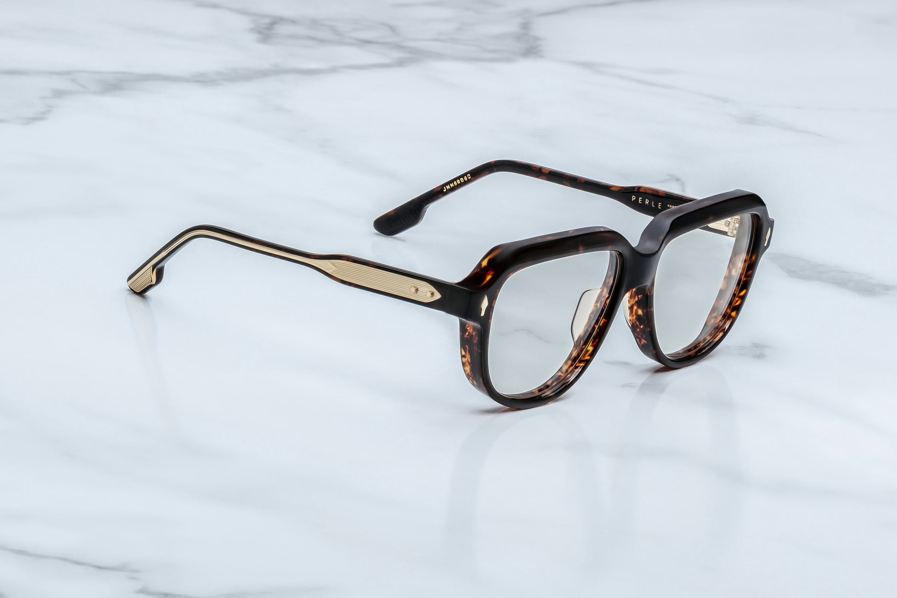 Tortoiseshell eyeglasses on a marble surface