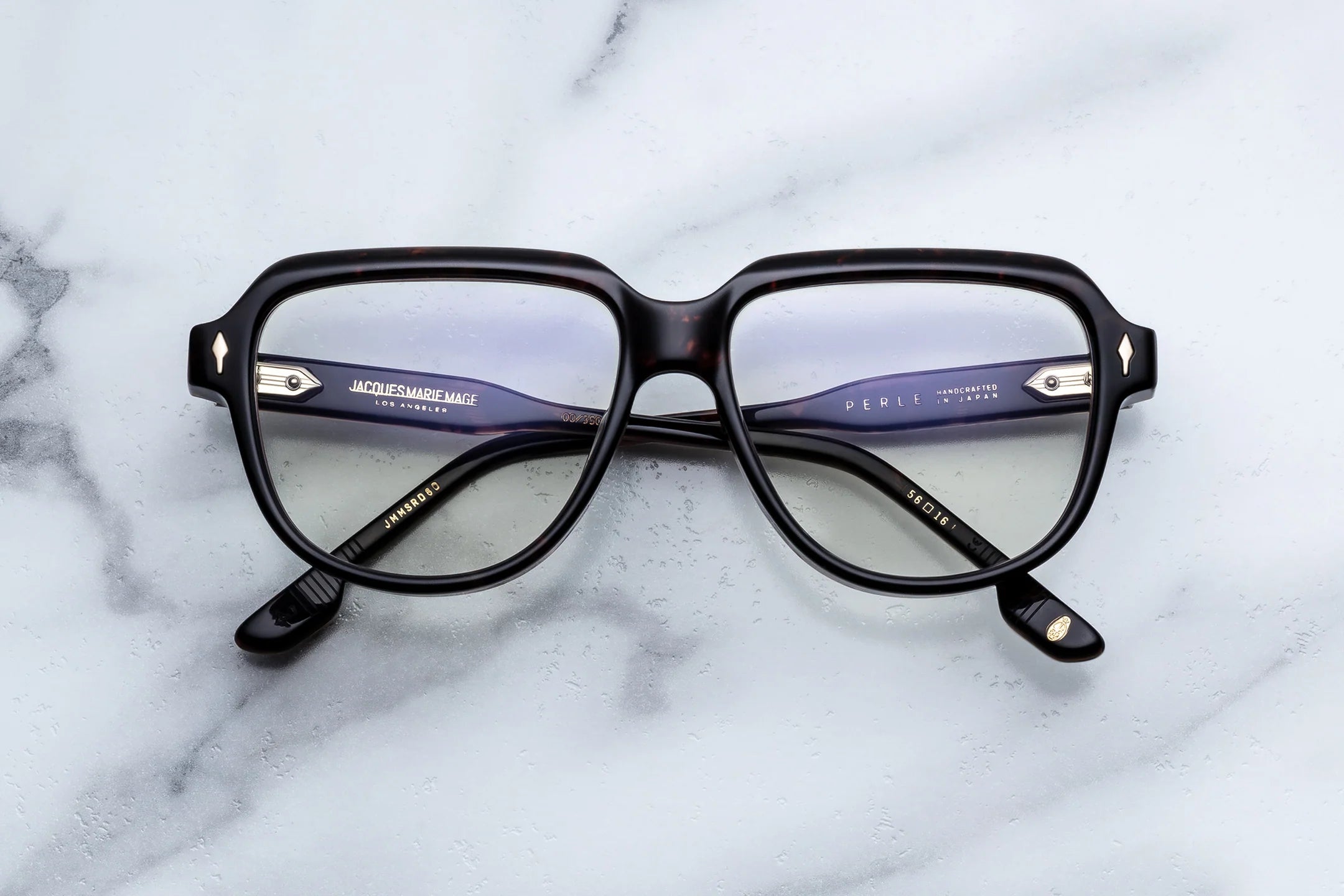 Black eyeglasses on a marble surface