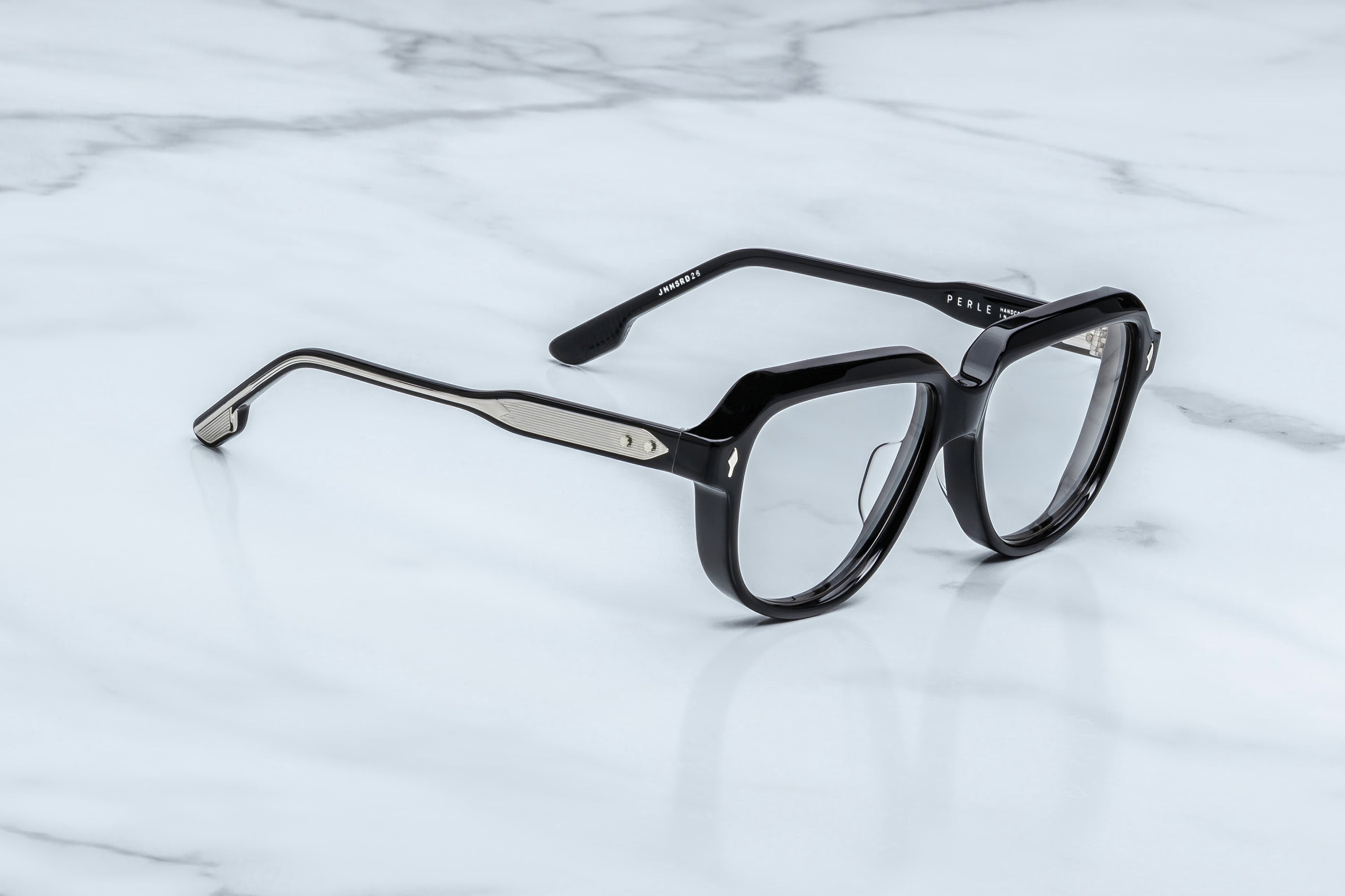 Black eyeglasses on a marble surface