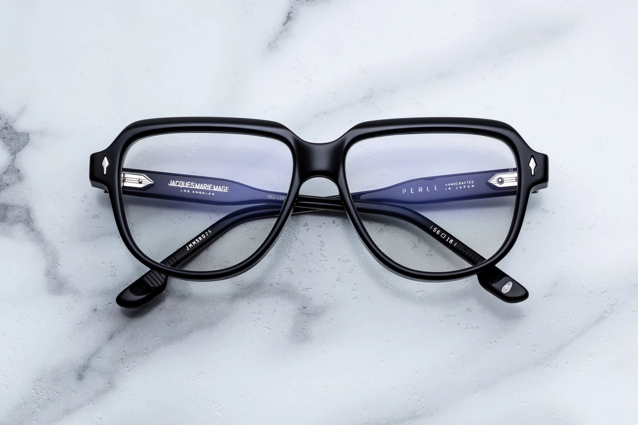 Black eyeglasses on a marble surface