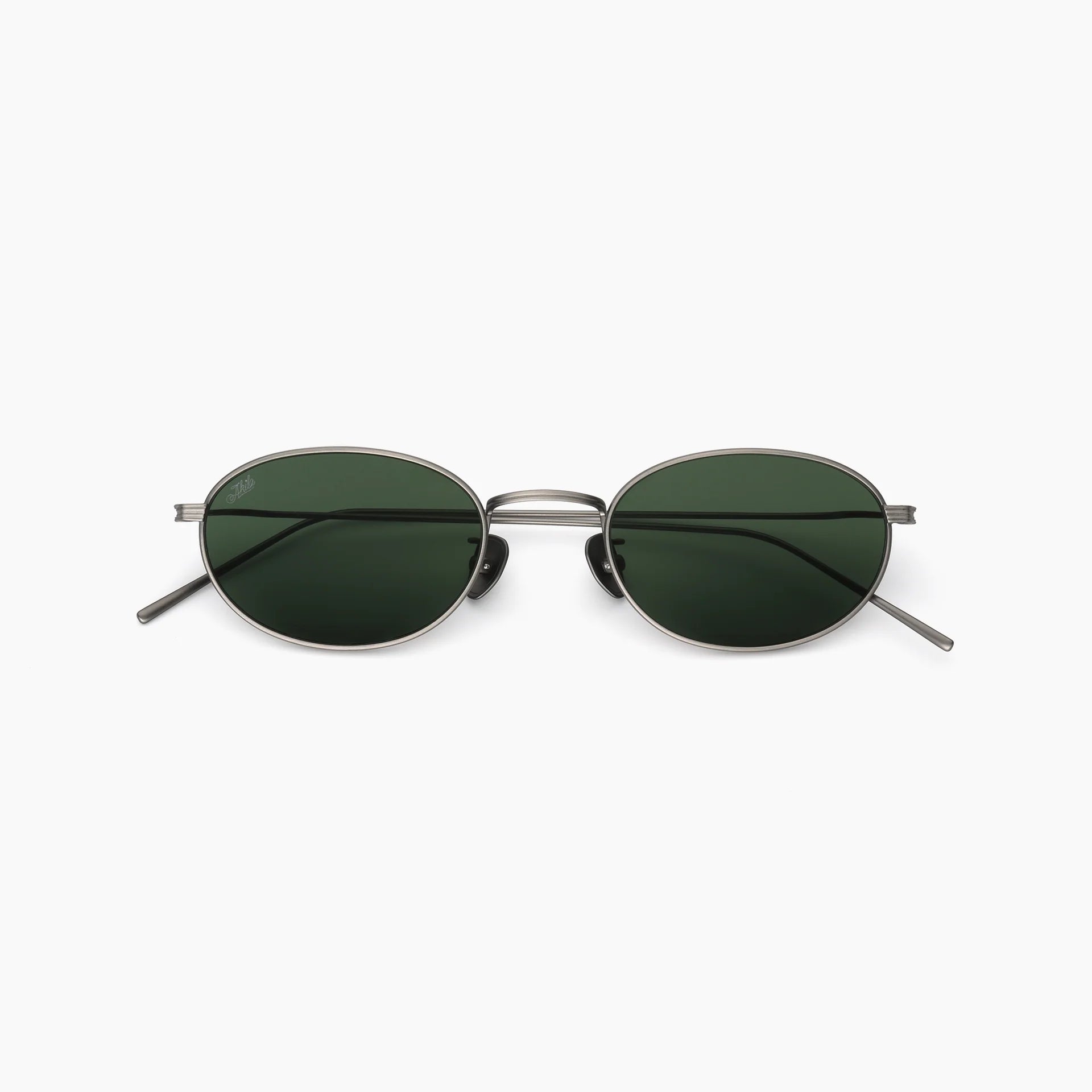 Oval metal-frame sunglasses with dark green lenses, slim temples, and a double bridge, shown front-facing on a white background.