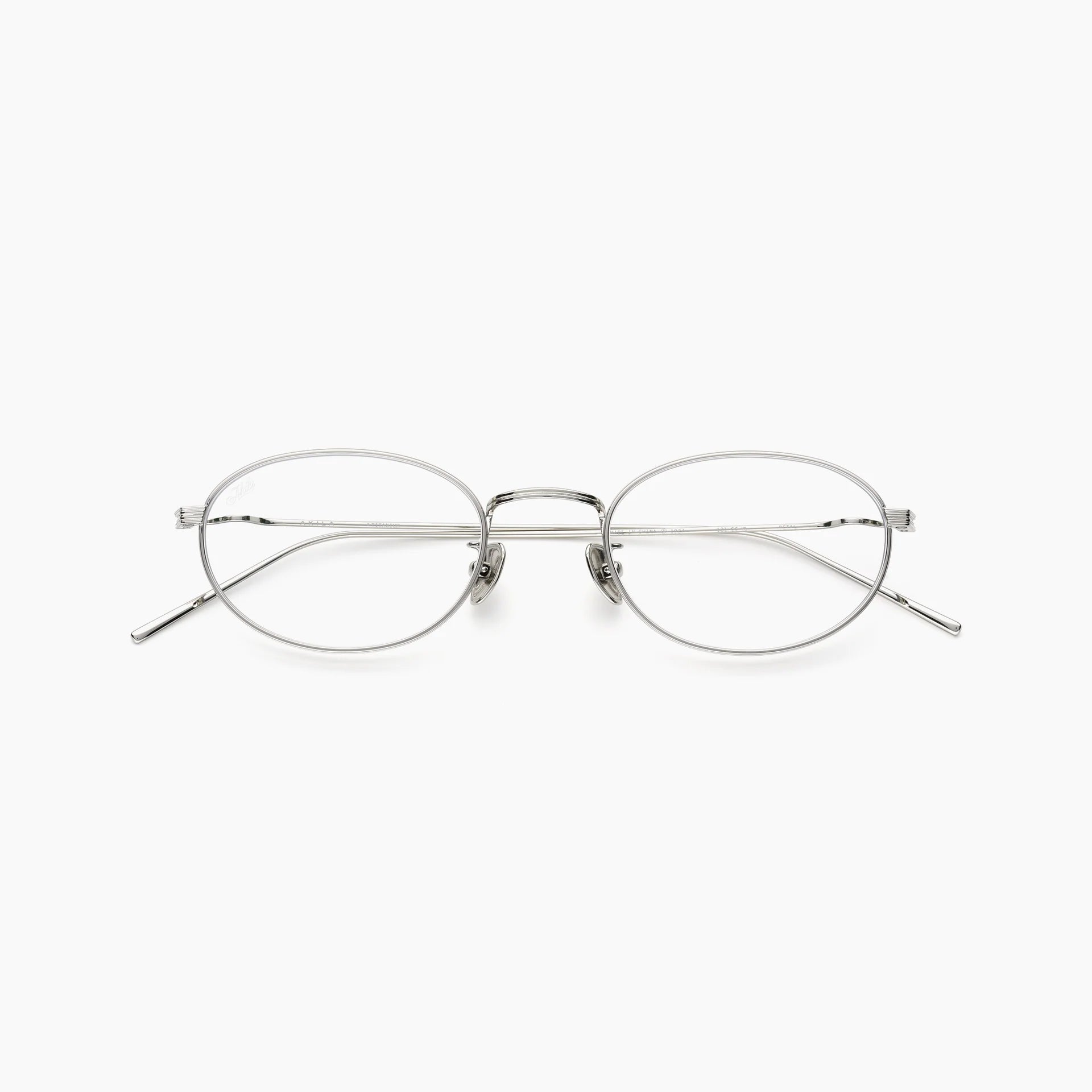Silver oval optical glasses with thin metal rims, clear lenses, adjustable nose pads, slim temples, and a double bridge, shown front-facing on a white background.