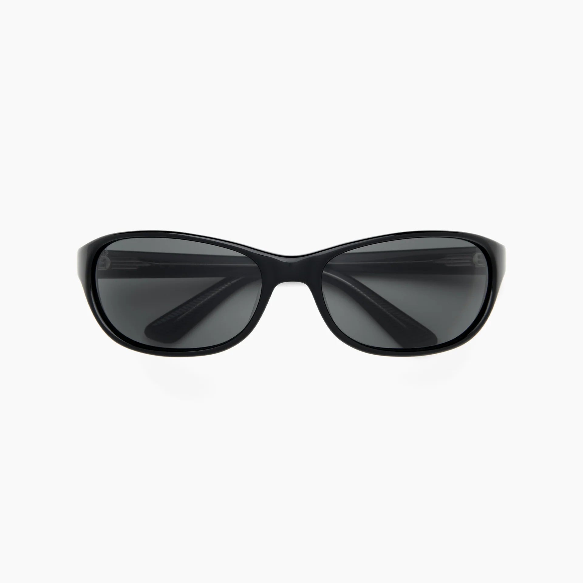 Black oval wrap-style sunglasses with dark grey lenses and a slim molded frame, shown front-facing on a white background.