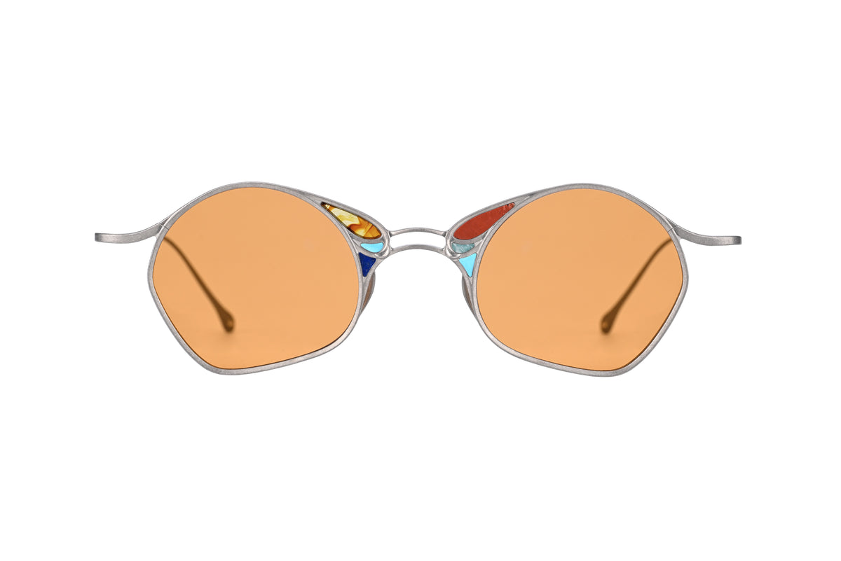 The RIGARDS RG1032TI sunglasses by RIGARDS feature orange-tinted UV400 sun lenses set in a thin silver frame, adorned with small colorful decorative accents near the bridge on each side. The slender silver arms curve slightly outward, adding a unique touch to these handmade sunglasses.
