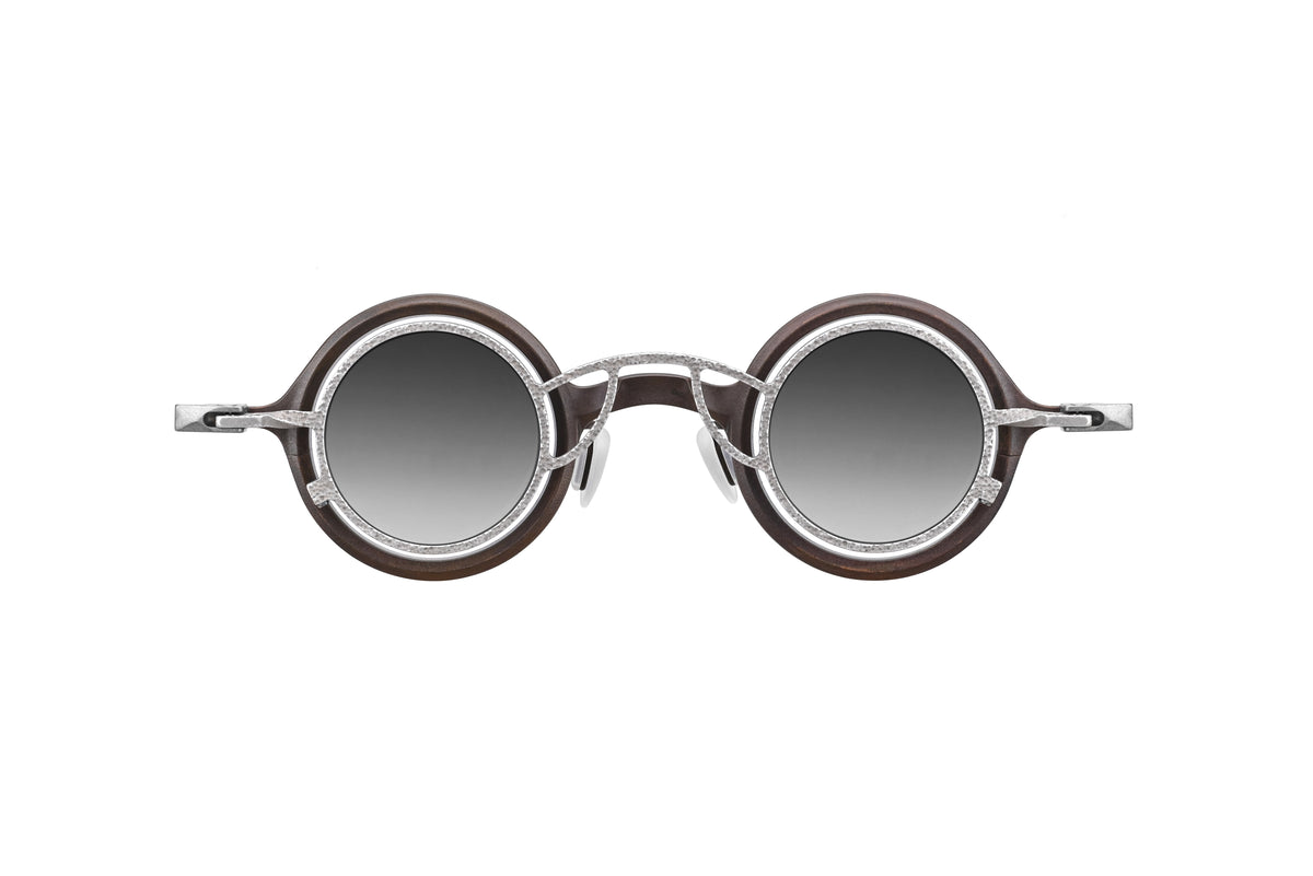 The RIGARDS RG1911TI sunglasses by RIGARDS feature dark UV400 sun lenses set in a brown circular acetate frame with sleek silver metallic arms. These spring hinge sunglasses are shown from a front-facing angle against a plain white background.