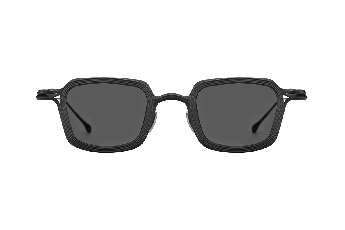 Front view of the RIGARDS RG2004TVA sunglasses by RIGARDS, featuring a black, square handmade frame with dark lenses and textured detailing around the rims, set against a plain white background.