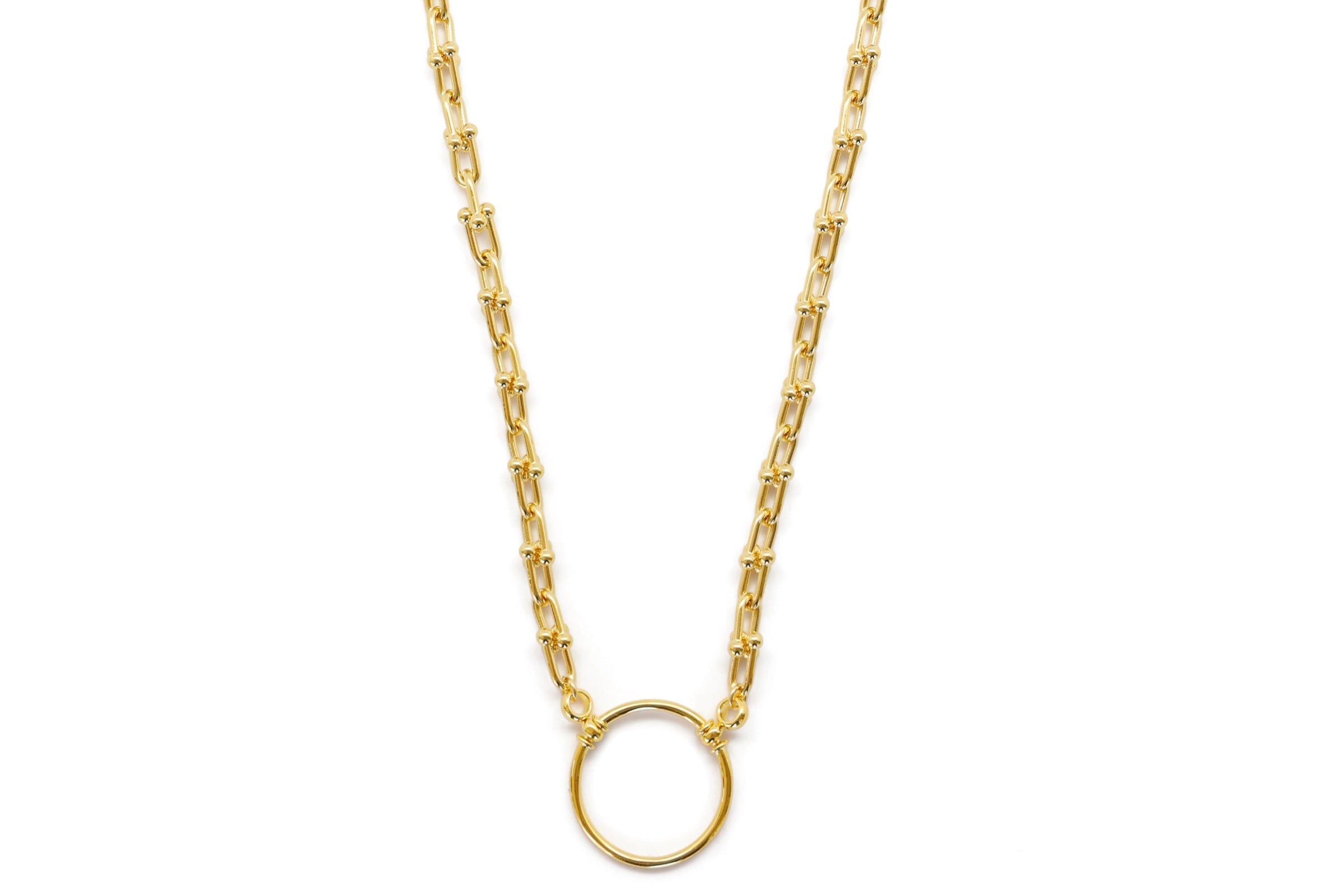 Gold necklace with a round pendant on a white background