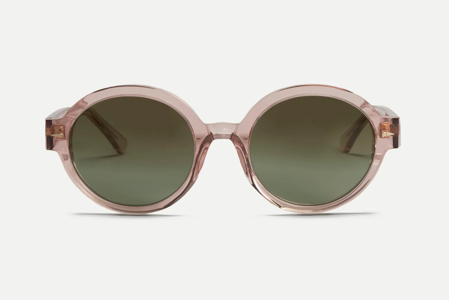 Oval sunglasses with a translucent blush pink frame and dark green lenses, shown from the front on a light gray background.