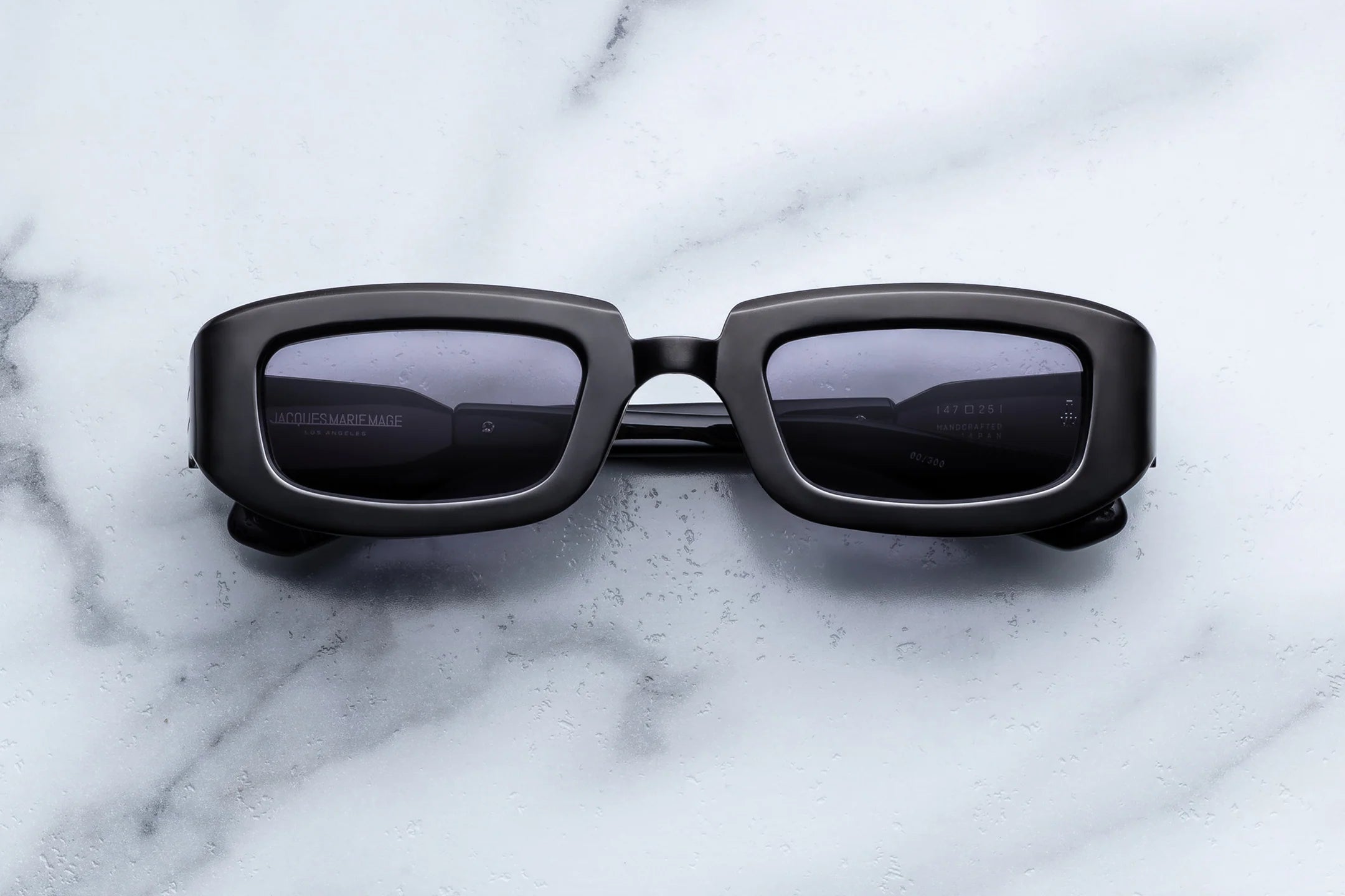 Black sunglasses on a marble surface