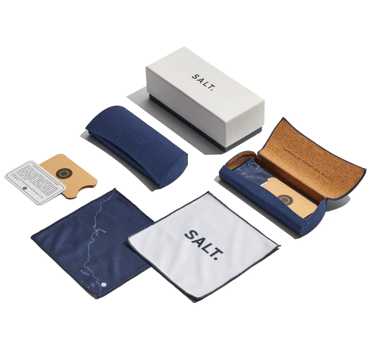 A SALT. Seine glasses case set features a white SALT. box, a blue padded case, an open cork-lined case, lens cloths, and a lens care card—all beautifully arranged on a white background to enhance your mid-century modern SALT. sunglasses collection.