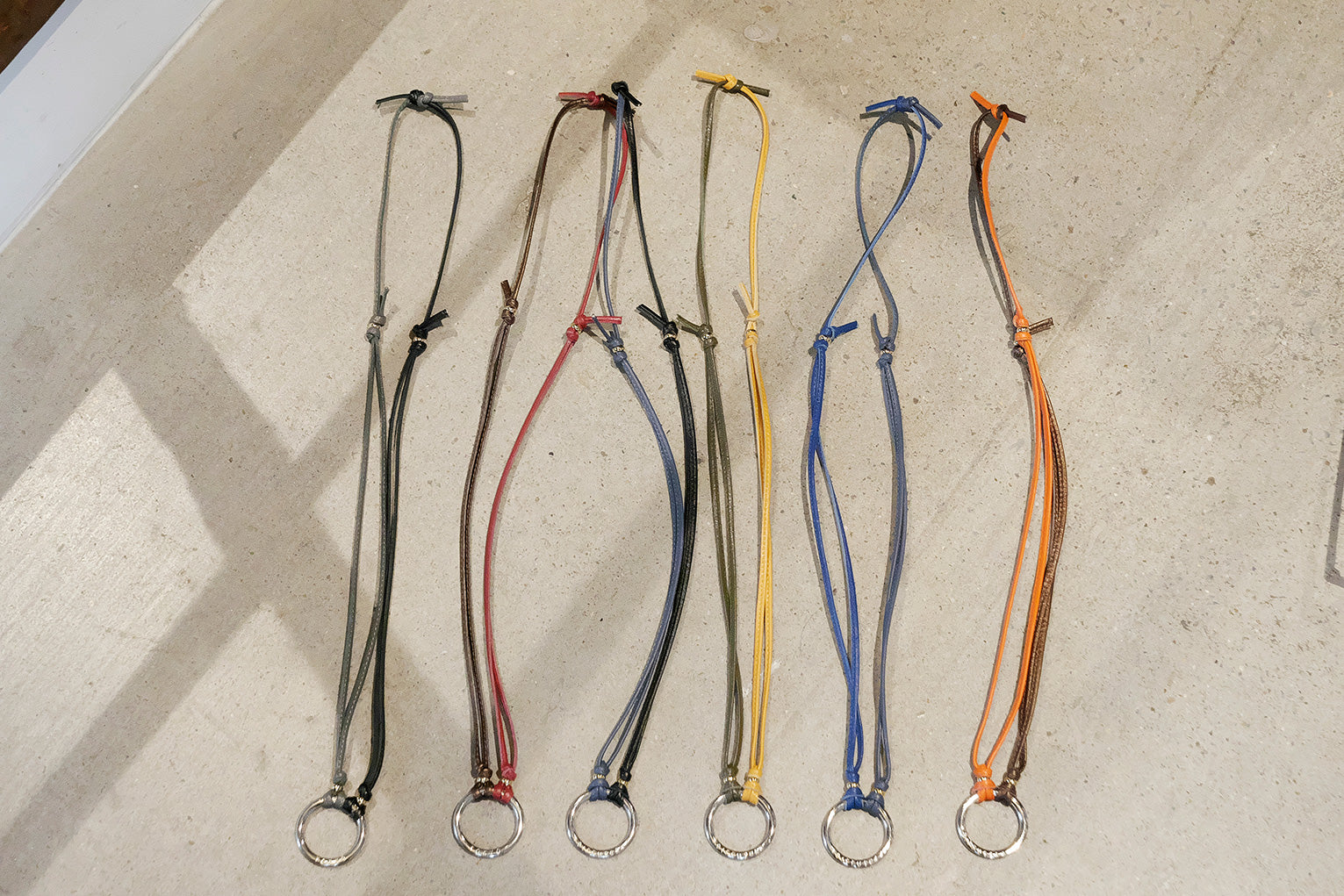 Set of six colorful lanyards on a textured surface