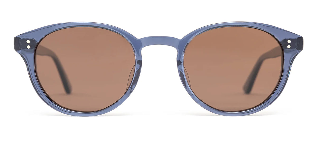The SALT. Spencer round sunglasses by SALT. feature translucent blue frames and brown lenses, expertly crafted from premium Japanese acetate optical frames and shown from the front against a white background.