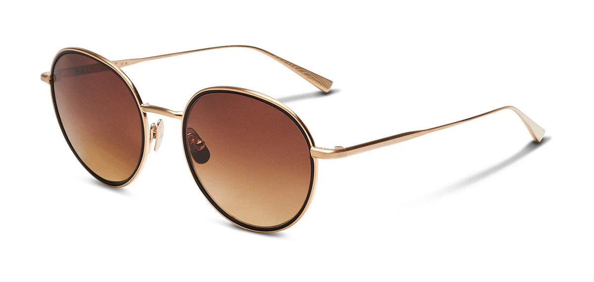 The SALT. Seine sunglasses by SALT. feature round frames crafted from thin gold metal and brown gradient lenses in a heritage style, displayed at an angle against a white background.