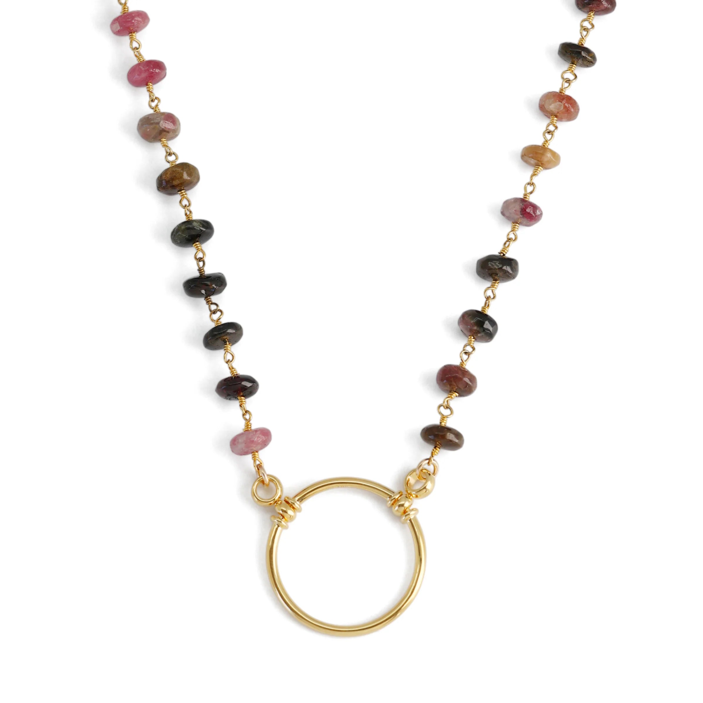 Necklace with multicolored beads and a gold ring pendant on a white background