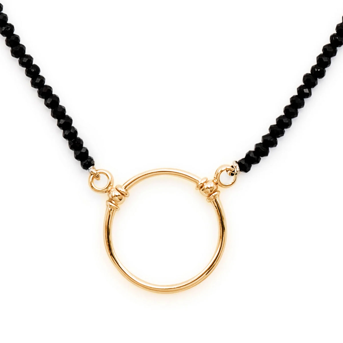 The La Loop Stella necklace features a central gold-plated ring attached to a chain of faceted black spinel beads.