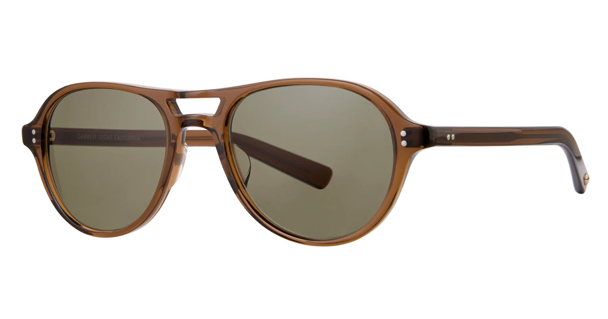 The Garrett Leight Hancock sunglasses by Garrett Leight are brown plastic aviator-style frames with dark lenses, a double bridge, and rounded edges, shown from an angle on a white background. These aviator sunglasses provide reliable UV protection while delivering timeless style.