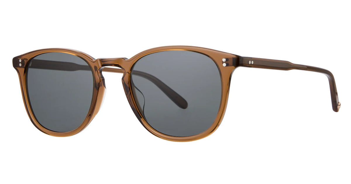 Garrett Leight Kinney 49 sunglasses in brown acetate feature round, premium glass lenses with dark tints, a keyhole bridge, and two small silver dots on each temple for a stylish finish, offering 100% UV protection.