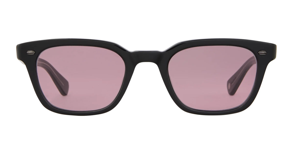 Garrett Leight Lugo sunglasses by Garrett Leight—black rectangular wayfarer style with thick frames and light purple-tinted UV-protective lenses—are displayed against a white background.