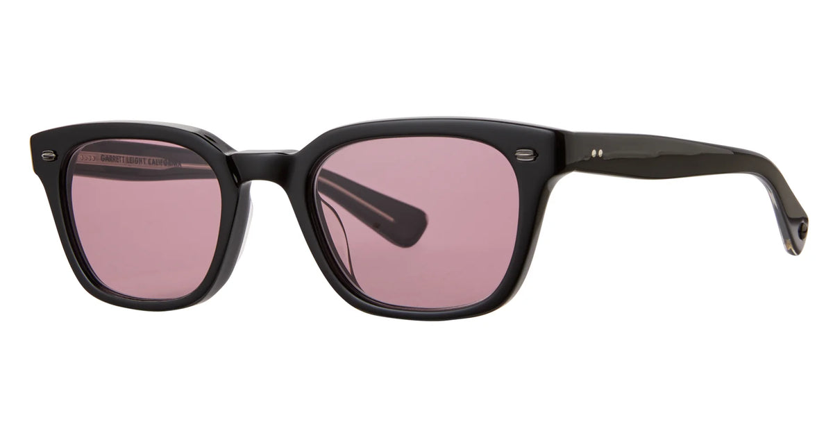 Garrett Leight Lugo sunglasses by Garrett Leight featuring a black rectangular wayfarer design, slightly thick arms, and pink-tinted UV-protective lenses, displayed on a white background.