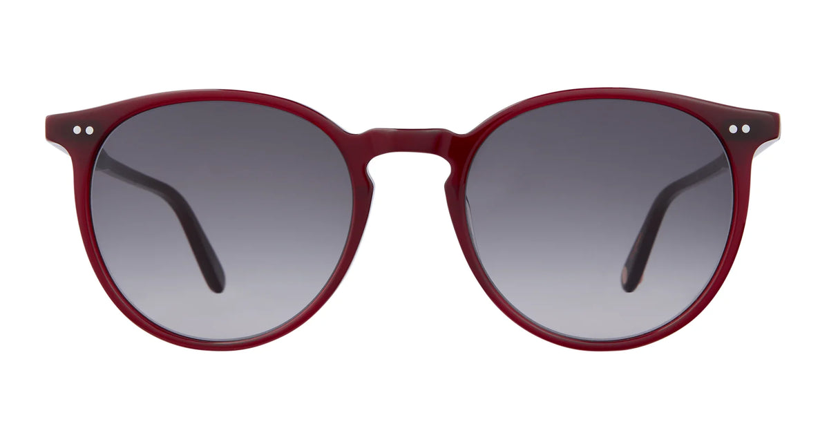The Garrett Leight Morningside sunglasses by Garrett Leight feature an oversized round silhouette with dark gradient lenses and a bold red acetate frame, presented front-facing on a white background for stylish UV protection.
