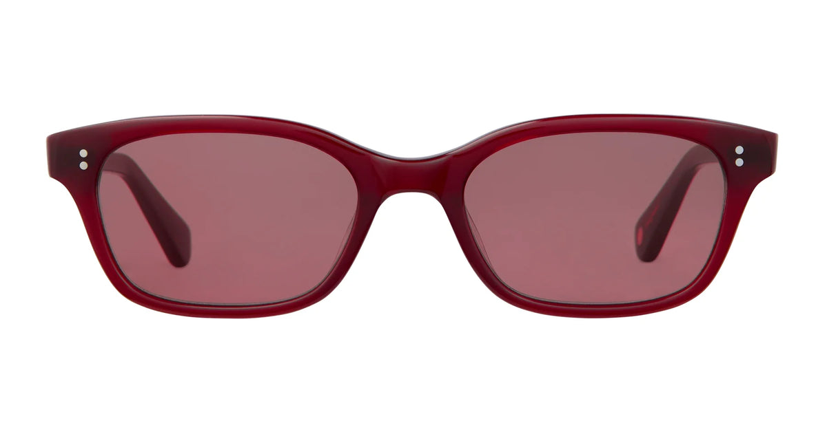 A pair of Garrett Leight Chaparral sunglasses in red, featuring rectangular frames with matching red tinted lenses, displayed front-facing on a white background. The frames include small silver accents at the outer top corners and provide 100% UV protection for your eyes.