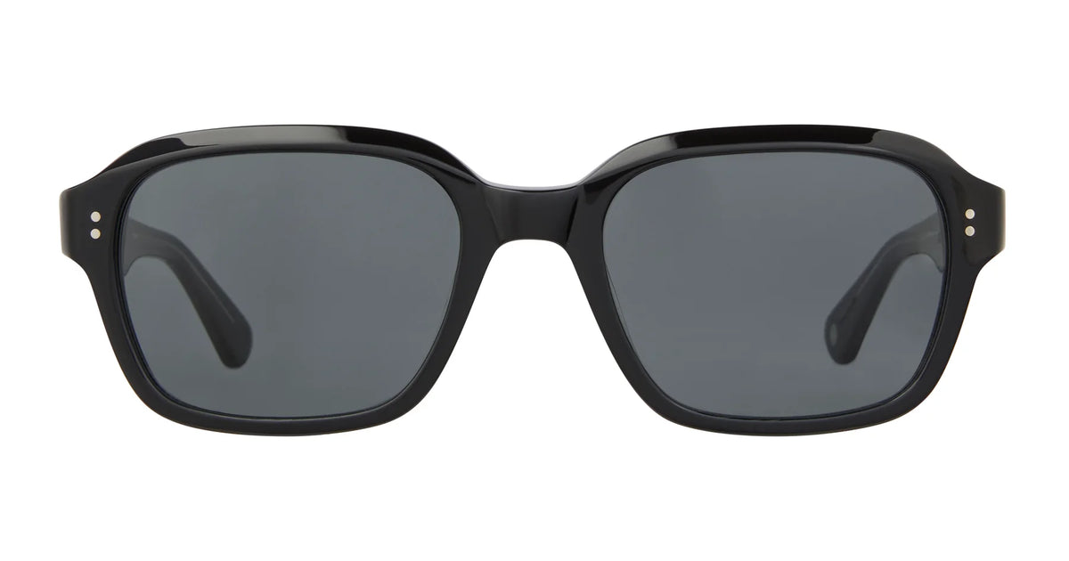 A pair of Garrett Leight Dominguez black vintage square sunglasses with dark lenses and 100% UV protection, viewed from the front against a white background.