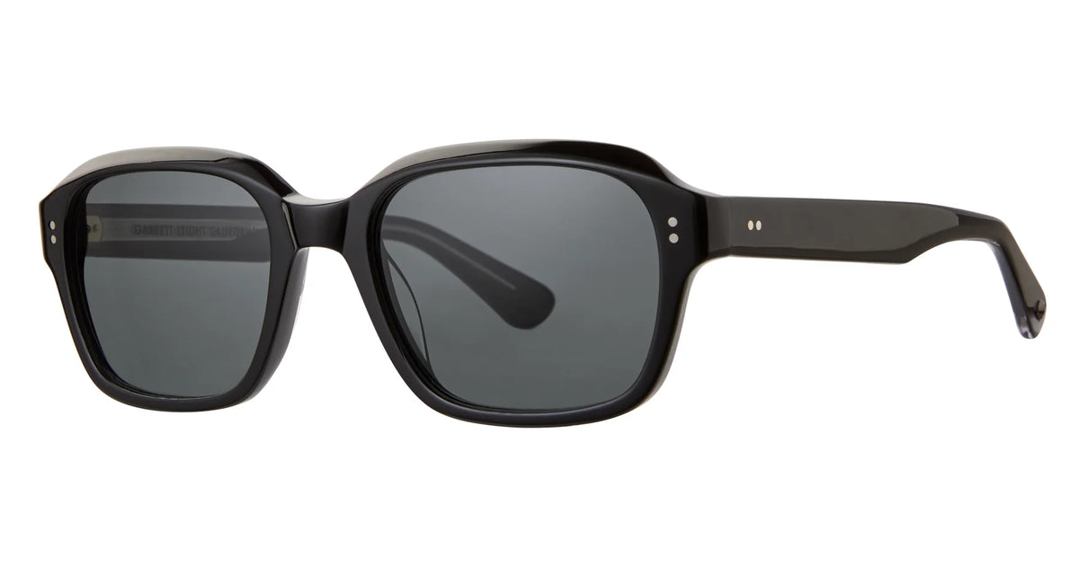 The Garrett Leight Dominguez by Garrett Leight are black rectangular sunglasses with thick frames and dark lenses that offer UV protection, shown against a white background.