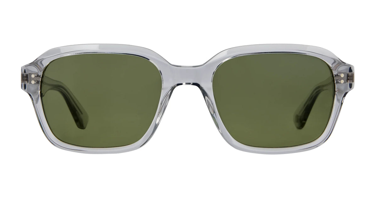 Garrett Leight Dominguez sunglasses by Garrett Leight feature a clear plastic frame and oversized, square-shaped green lenses that provide 100% UV protection. These vintage-inspired square sunglasses are displayed from the front against a white background.
