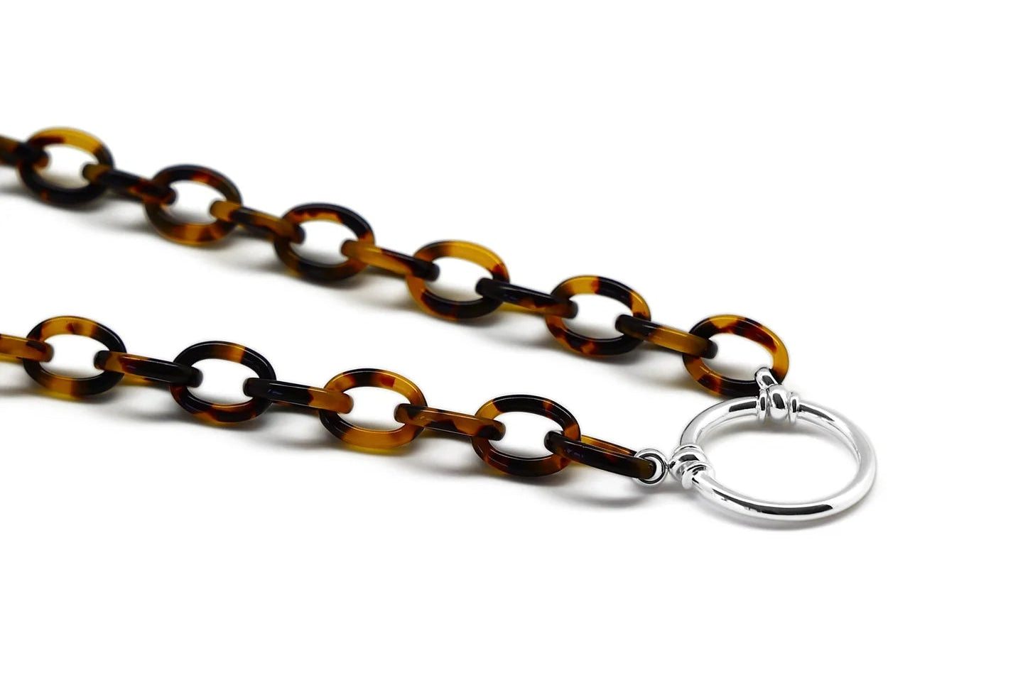 Tortoiseshell chain necklace with a silver clasp on a white background