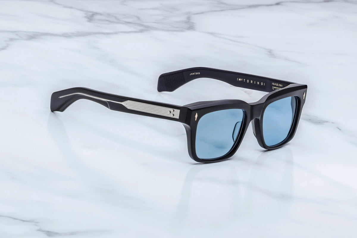 Jacques Marie Mage Torino black rectangular sunglasses featuring ’60s-inspired light blue lenses and silver filigree detailing on the temples.