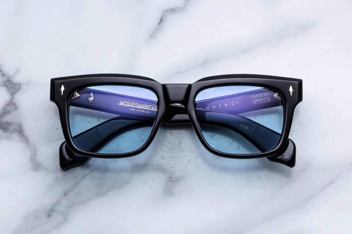 Jacques Marie Mage Torino ’60s-inspired black-framed sunglasses with light blue lenses and gold-toned arrowhead rivets at the temples.