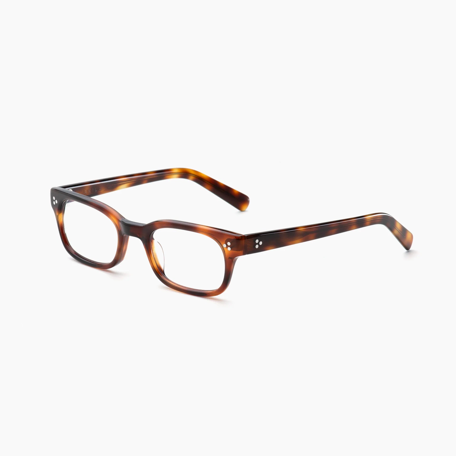 Akila introduces the Tracer eyeglasses, featuring thick tortoiseshell acetate in a modern rectangular design with optional blue light blocking lenses, displayed at an angle on a white background.