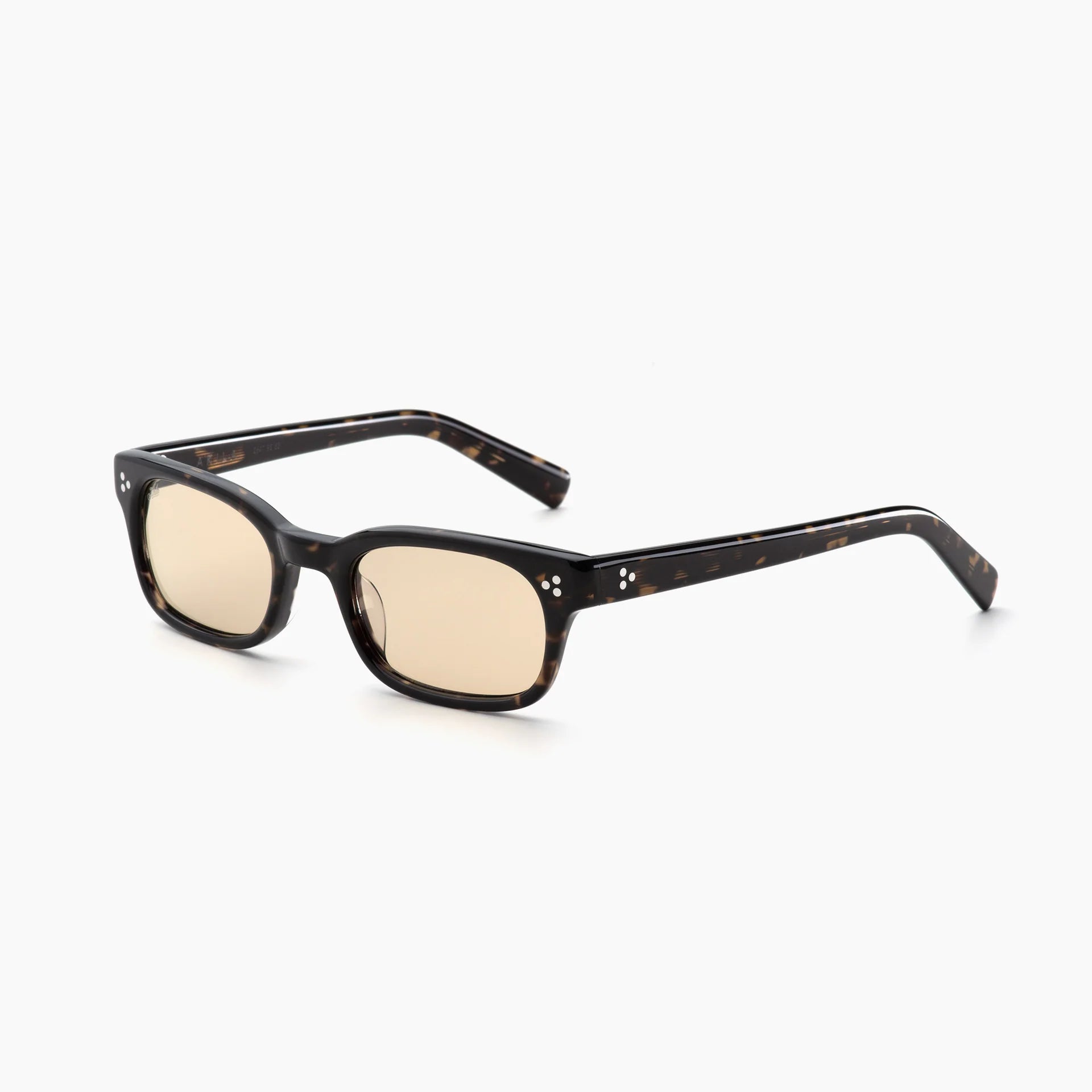 Dark tortoise rectangular acetate sunglasses with light yellow-tinted lenses, white rivet accents, and thick temples, shown at an angled side view on a white background.