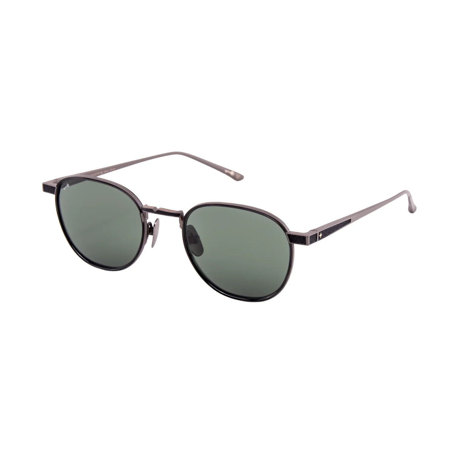 The Leisure Society Verlaine sunglasses by Leisure Society feature round, black-rimmed frames with dark green polarized Trivex sun lenses and thin metal arms, displayed on a white background.
