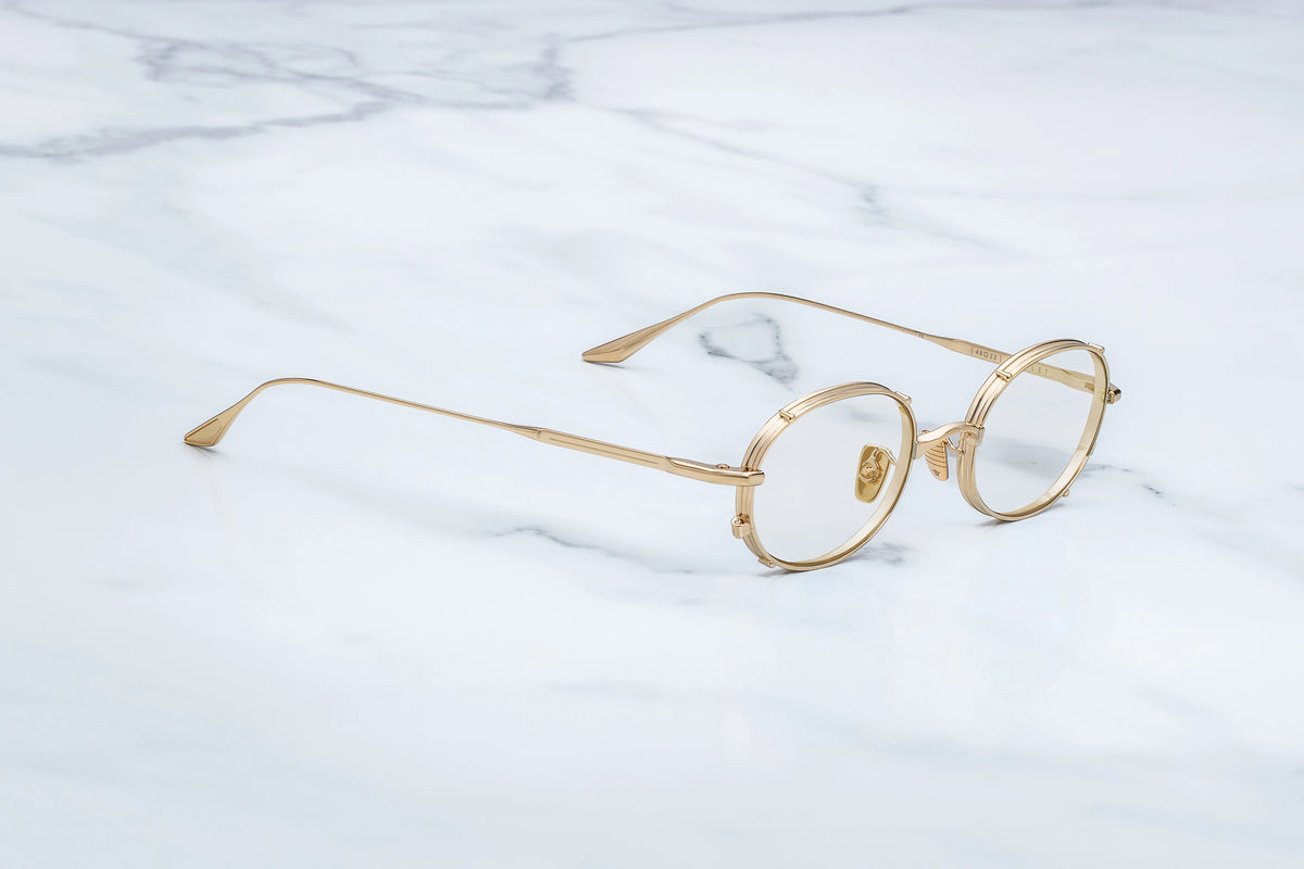 Jacques Marie Mage Violet glasses with thin, round, gold-tone metal frames.