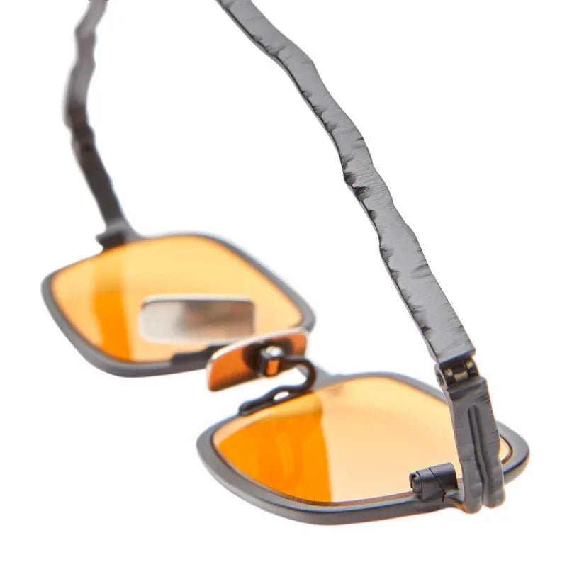 Sunglasses with orange lenses and gray strap on a white background