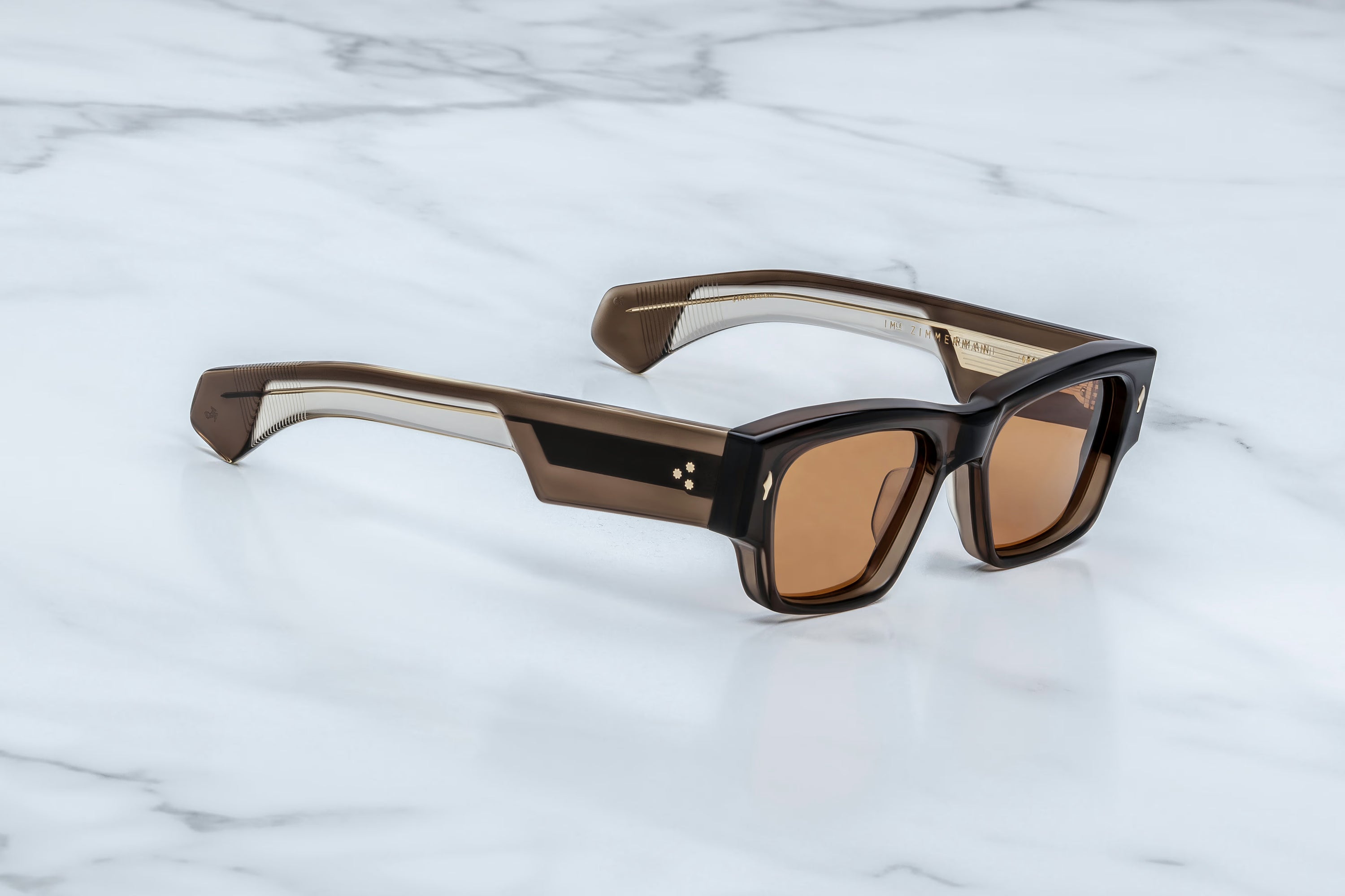 Sunglasses with brown lenses on a marble surface