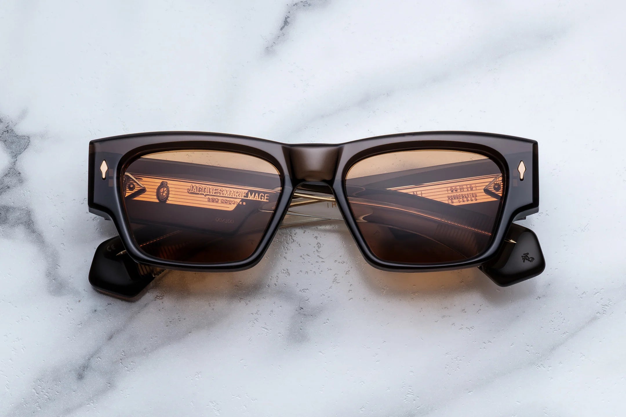 Sunglasses with a reflective surface on a marble background