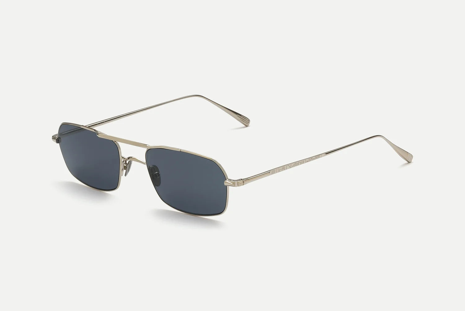 A pair of AHLEM Trevise rectangular aviator sunglasses by AHLEM, handcrafted in France with thin 22k gold metal frames and dark rectangular lenses, displayed on a white background.