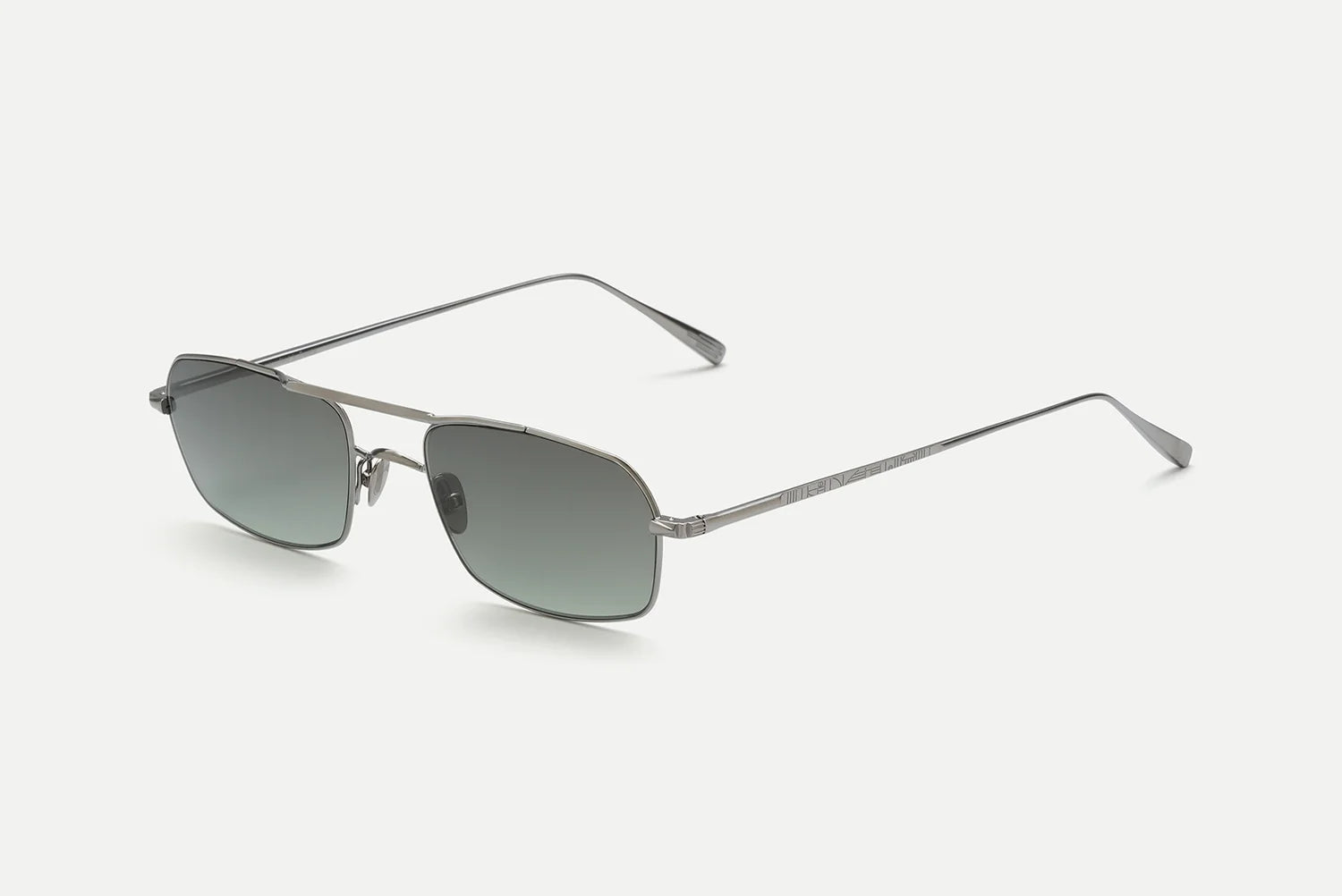 The AHLEM Trevise, handcrafted in France by AHLEM, features a silver metal frame in a rectangular aviator shape with slightly tinted gray lenses and thin arms, displayed on a white background.